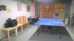 Bottom Level: Game room with ping-pong and foosball tables